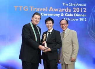 Royal Cliff Hotels Group Vice-President Vathanai Vathanakul (center) receives the TTG Hall of Fame award from Michael Chow, TTG Travel Trade Publishing.